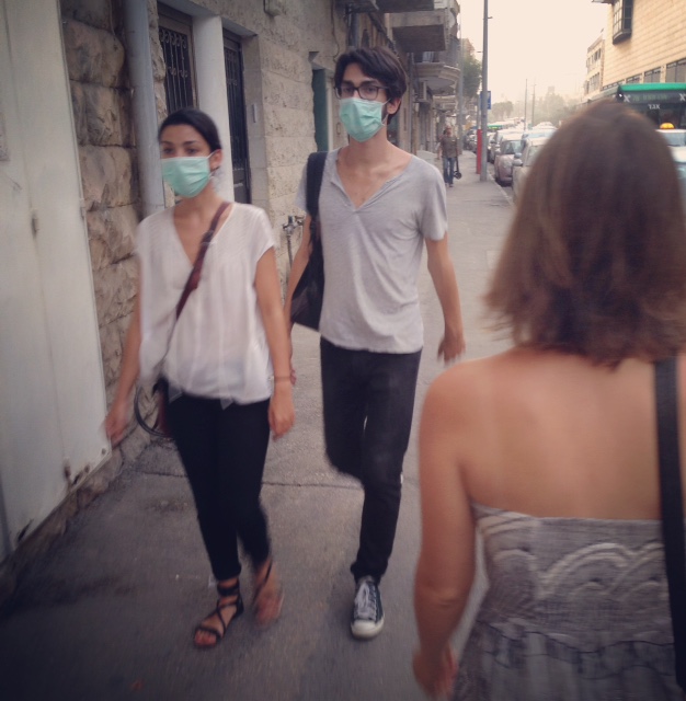 On our way to the bus stop, Jerusalemites protect themselves against the dusty weather